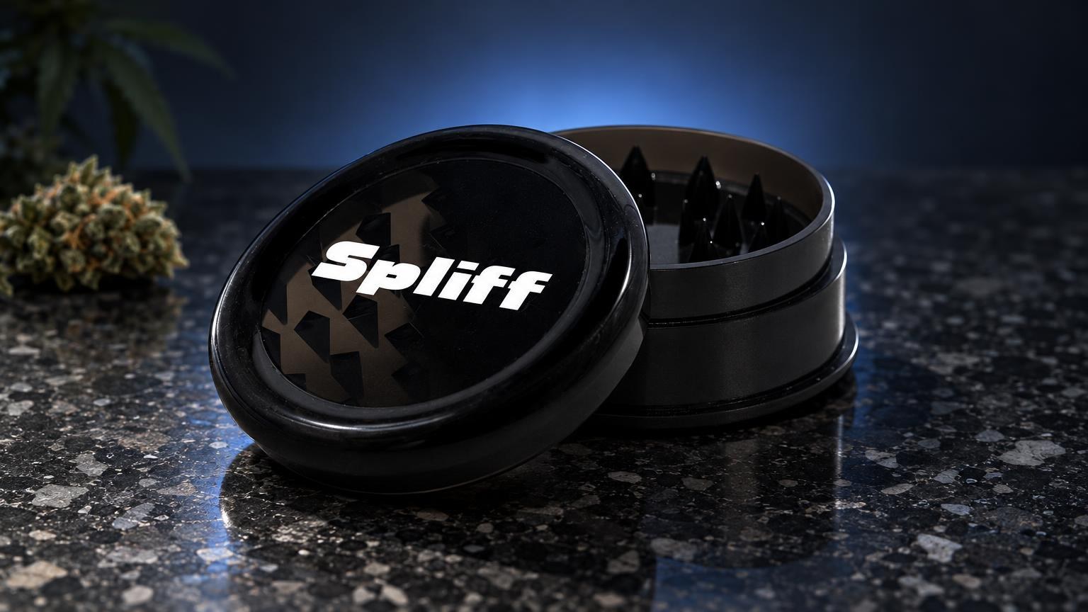 Black metal grinder with teeth inside chamber and branded lid, displayed open on dark surface