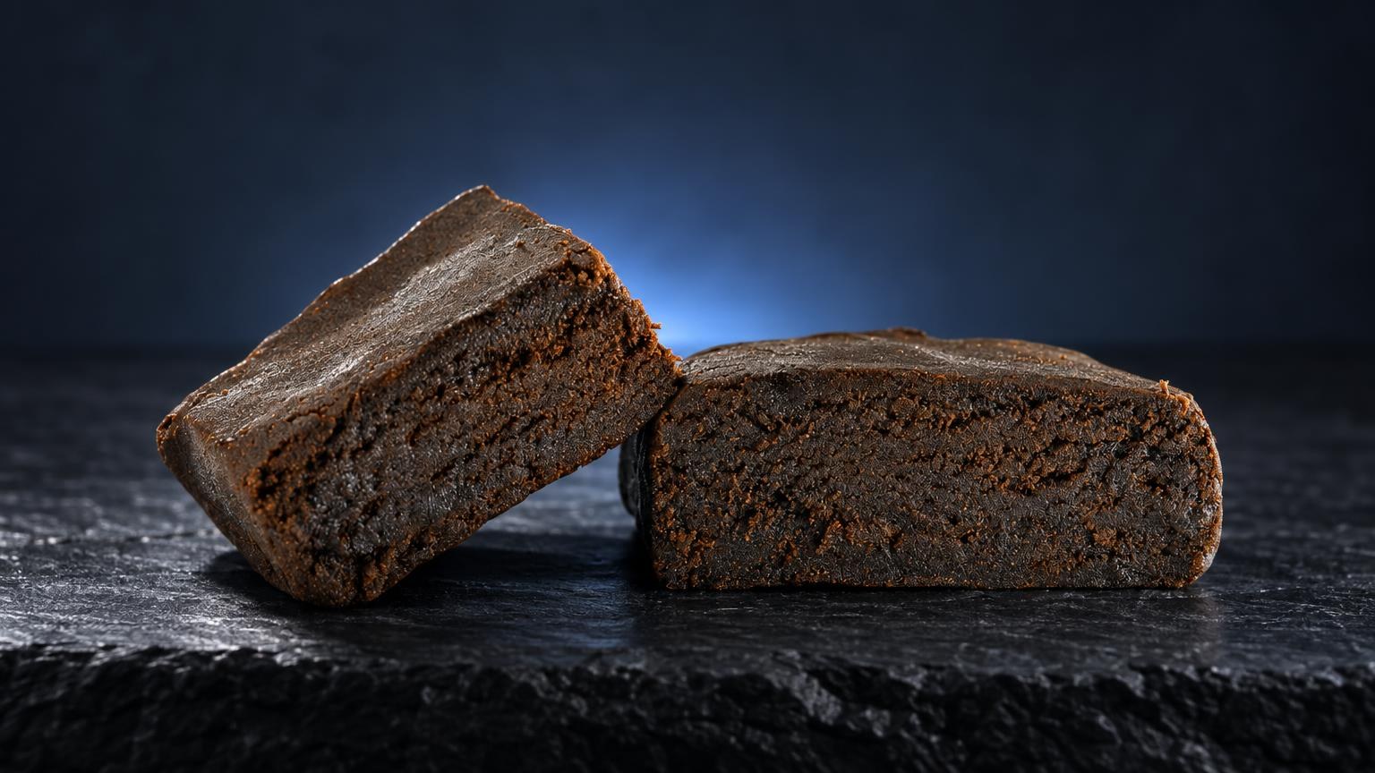Moroccan Hash: two brown compressed blocks with dense texture on dark surface, showing traditional hash format