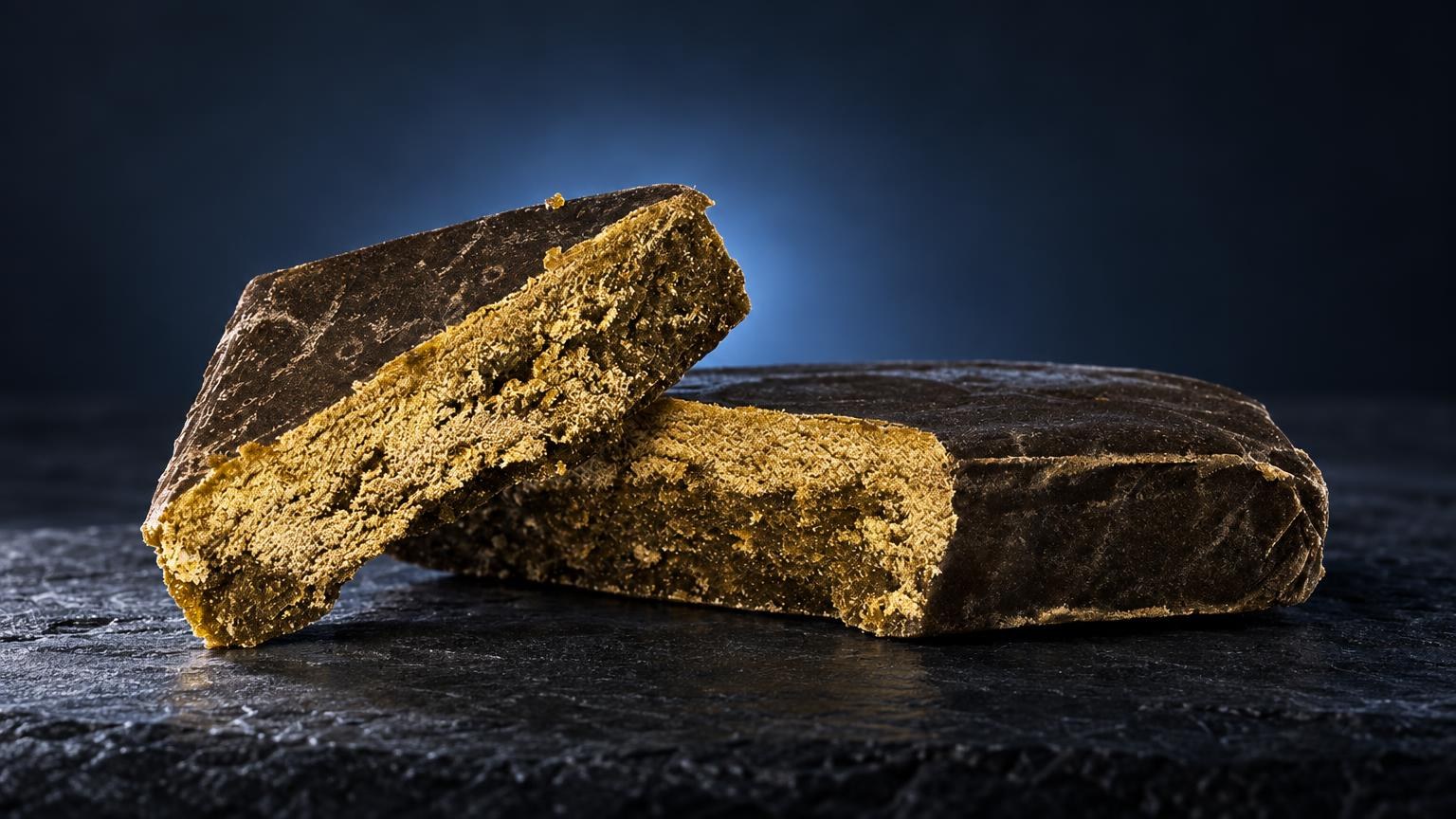 Three golden-brown solventless hash blocks with textured surfaces on dark background, illustrating Static Hash product form